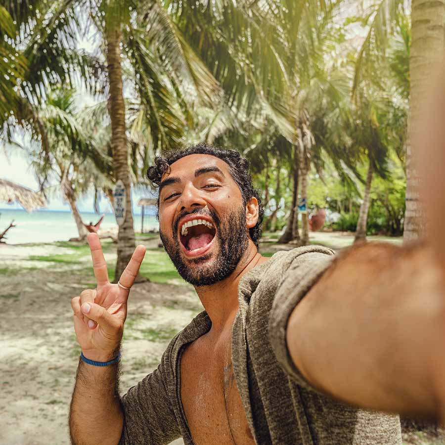man posing for the camera at the beach