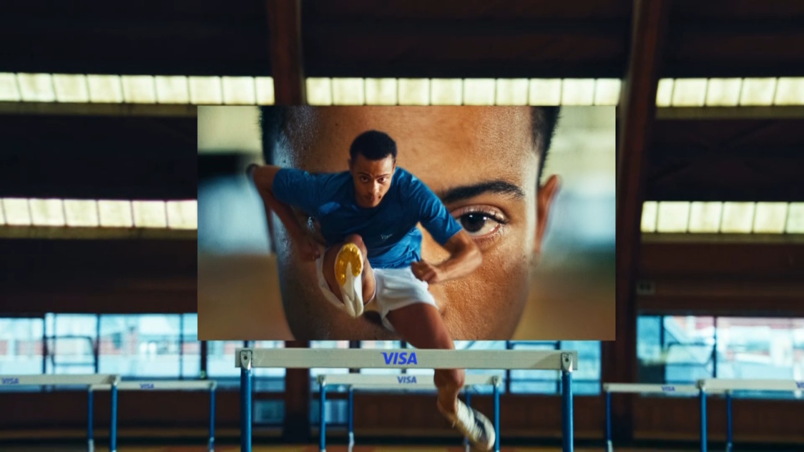 man running over hurdles