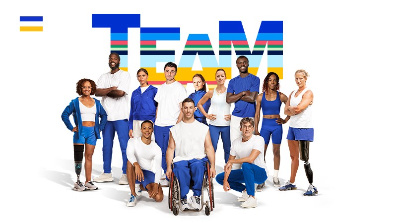 Olympic and Paralympic athletes in front of a large sign that says team.