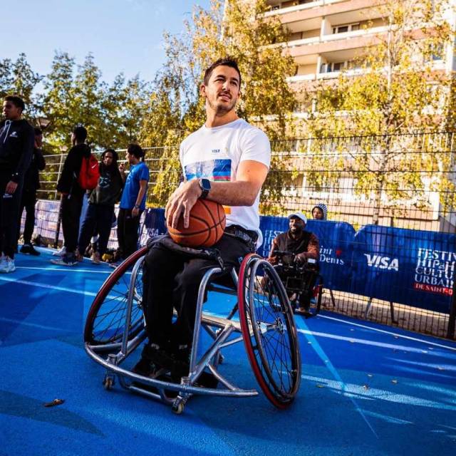 paralympic athlete on wheelchair with basketball